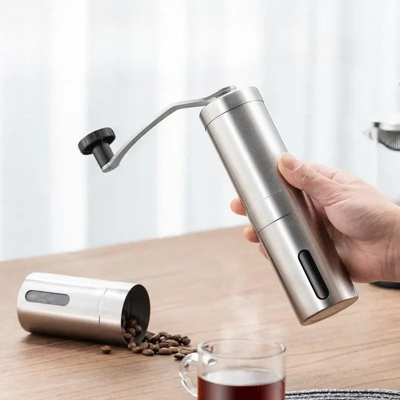 Manual coffee grinder set made of stainless steel with a container for beans, ideal for home kitchen and outdoor use.