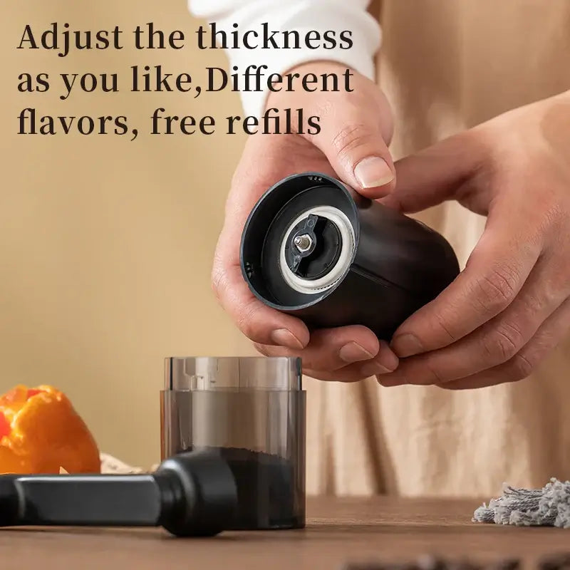 Manual ceramic coffee grinder with adjustable thickness and transparent powder bin for easy cleaning.